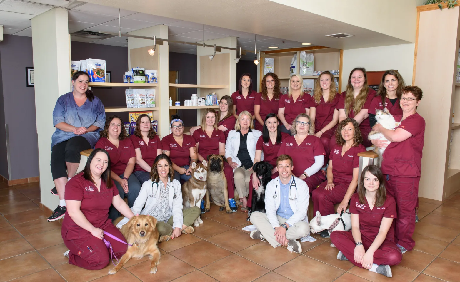 Group Photo of veterinary staff in burgundy scrubs at South Suburban Animal Hospital